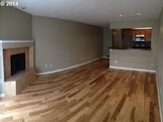 an empty living room with hard wood floors and no furniture in the house or apartment