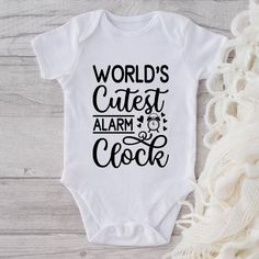 a white onesuit with the words world's cutest alarm clock on it