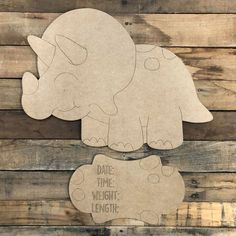 an elephant cut out from cardboard with the words date time, weight and length on it