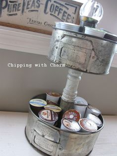 an old metal bucket filled with beer cans and a lamp on top of a table