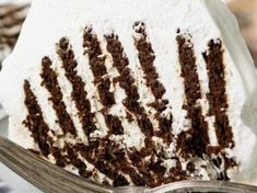 a piece of cake with white frosting and chocolate icing is on a plate