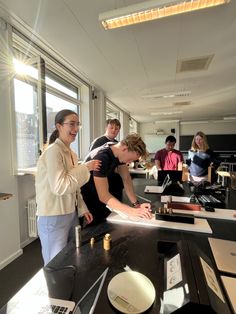 a group of people standing around a table