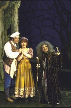 three people dressed in costumes standing next to each other