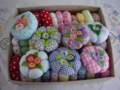 a box filled with lots of different types of fabric flowers