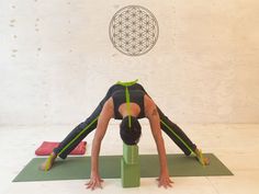 a woman is doing yoga in front of a flower of life symbol