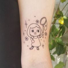 a small tattoo on the wrist of a girl with a balloon and star in her hand