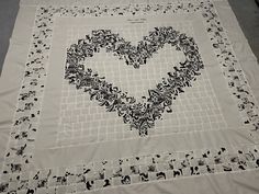 a heart - shaped piece of cloth with black and white designs on it, sitting on a table