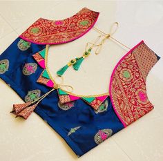 two pieces of blue and pink silk saree with tassels on the neck