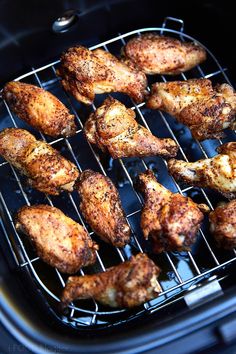 chicken wings cooking on the grill in an air fryer, ready to be cooked