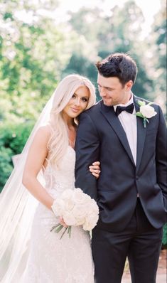 a bride and groom pose for a wedding photo