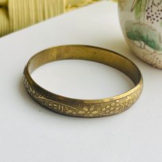 Cool 60s brass boho bangle etched with stripes and flowers. Great patina! Great for your growing stack of bangles. Will fit right in! Vintage Handmade Bangle For Wedding, Bohemian Antique Finish Cuff Bangle Bracelet, Bohemian Bangle Cuff Bracelet With Antique Finish, Vintage Ceremonial Bangle With Antique Finish, Vintage Engraved Cuff Bracelet For Festival, Bohemian Brass Cuff Bracelet For Wedding, Adjustable Vintage Bangle, Vintage Brass Cuff Bracelet For Festivals, Vintage Bronze Cuff Bracelet For Festival