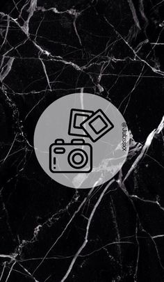 a black and white marble background with a camera