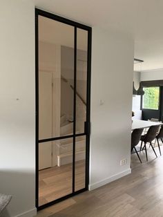 an empty room with some chairs and a sliding glass door on the wall in front of it