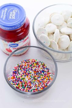 two bowls filled with sprinkles next to a jar of yogurt