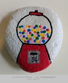 a rock with a gummy machine painted on it