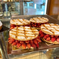 waffle sandwiches with strawberries are on display