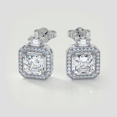 This beaming set of earrings will have you mesmerized by its whimsical design. A stunning pave halo complete with beaded milgrain surrounds our dazzling Asscher cut simulated diamonds. Further embellished by a brilliant baguette stone set over the top of each stunning earring. A perfect gift.  Asscher Cut Halo Earrings Center Stone: 1.5CT Each Total Carat Weight: 3.38CTW Stone Clarity: VVS-1 Available in: 14K White Gold Model: ER2497-WH Halo Earrings, Gold Models, Asscher Cut, Whimsical Design, Stunning Earrings, Over The Top, Stone Settings, Halo, White Gold