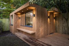 a small wooden building sitting next to a tree