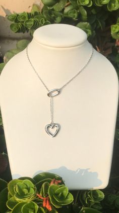 Beautiful lariat has a heart on the end. The sterling silver chain is 21 inches if measured all the way around. Stunning, classy gift of love! Elegant Adjustable Lariat Necklace With Heart Pendant, Elegant Lariat Necklace With Heart Charm, Elegant Adjustable Heart Pendant Lariat Necklace, Elegant Lariat Necklace For Valentine's Day Anniversary, Elegant Heart-shaped Lariat Necklace, Heart-shaped Lariat Necklace With Clavicle Chain, Elegant Lariat Heart Charm Necklace, Elegant Heart Lariat Necklace With Adjustable Chain, Elegant Lariat Heart Necklace With Adjustable Chain