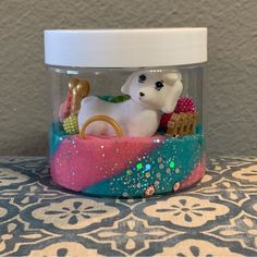 a glass jar with a white dog in it