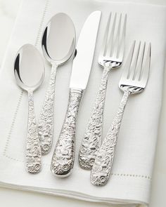 four silverware on top of a white napkin