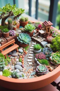 a potted planter filled with lots of succulents and rocks next to a wooden bench