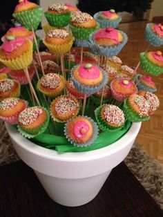 cupcakes with sprinkles and pink frosting in a white bowl