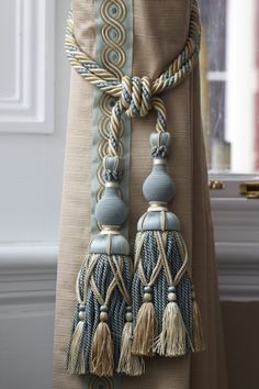 a curtain with tassels hanging from it's side