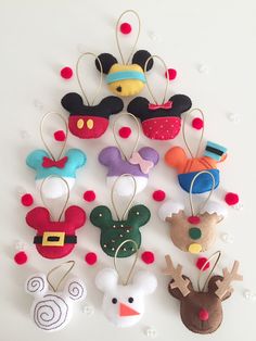 a group of mickey mouse head ornaments hanging on a wall