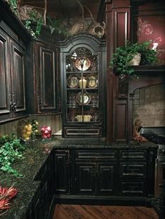 an image of a kitchen setting with black cabinets and granite counter tops in the center