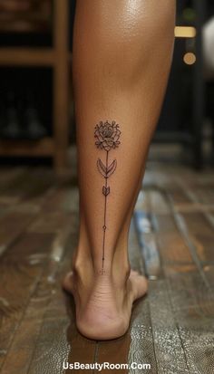 a woman's foot with a flower tattoo on it and the bottom part of her leg