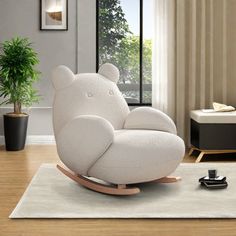 a white rocking bear chair in a living room