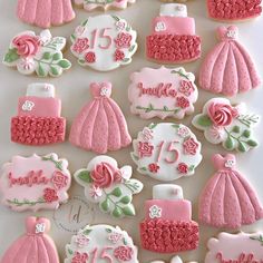 decorated cookies are arranged in the shape of princess dresses and tiaras, with pink icing