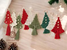 christmas tree ornaments are hanging on the wall next to pinecone cones and fir trees