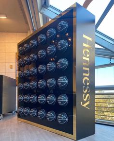 a large display case sitting inside of a building next to a glass window with the word hensey on it