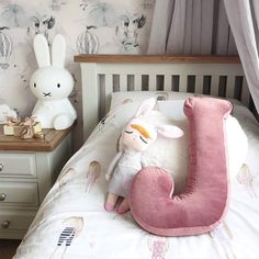 a stuffed animal sitting on top of a bed