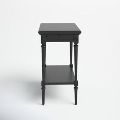 a small black table with one drawer on it