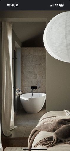 an image of a bedroom setting with a bathtub