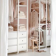 a white closet filled with lots of clothes