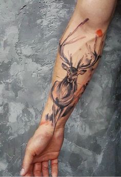 a hand with a deer tattoo on it