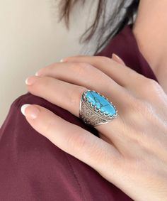 This 925 sterling silver cocktail ring with a stunning filigree pattern and a Turquoise gemstone exudes refinement and sophistication.The exquisite filigree art offers a lovely contrast, making it ideal for any formal occasion. This gorgeous accessory will enhance your look.The face of the ring is 0.80 inch long and 0.70 inch wide, and the Turquoise gemstone is 8x22 mm and has a cabochon oval shape.This ring is a work of art, with fine metal strands masterfully fashioned to create a lovely blend Turquoise Fine Jewelry Ring, Classic Formal Turquoise Ring, Classic Turquoise Ring For Formal Occasions, Blue Bohemian Jewelry With Accent Stones, Turquoise Fine Jewelry With Accent Stones, Elegant Turquoise Ring Gift, Fine Jewelry Silver Turquoise Ring With Accent Stones, Turquoise Sterling Silver Jewelry With Accent Stones, Fine Jewelry Turquoise Ring With Accent Stones In Silver