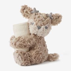 a stuffed animal with horns and a bandage in it's back paws, sitting on a white background