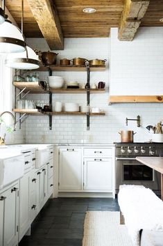 the instagram page shows an image of a kitchen with white cabinets and open shelving