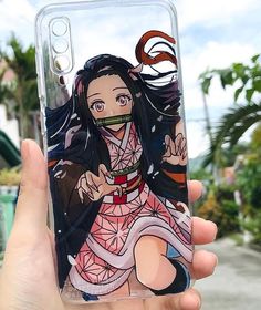 a person holding up a phone case with an anime character on it