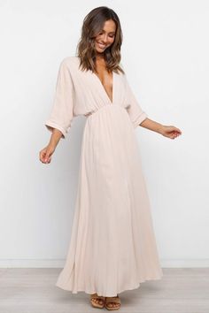 Bayview Dress - Beige - Petal & Pup USA Elegant Oversized V-neck Maxi Dress, Oversized V-neck Maxi Dress For Day Out, Oversized V-neck Midi Dress For Daywear, Oversized V-neck Maxi Dress For Vacation, Flowy V-neck Maxi Dress For Day Out, Flowy Beige V-neck Dress For Spring, Flowy Maxi Length V-neck Dress For Day Out, Relaxed Fit V-neck Maxi Dress For Vacation, Summer Day Out Maxi Dress With 3/4 Sleeves