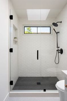 a bathroom with a shower, toilet and sink in it's center area is shown