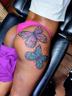 a woman's thigh with butterfly tattoos on her leg and the bottom part of her thighs