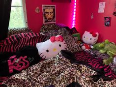 hello kitty stuffed animals are laying on a bed with pink walls and leopard print sheets