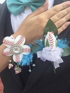 a person in a tuxedo with two baseball flowers on their lapel covers