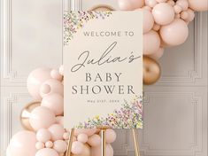 a welcome sign and balloons in front of a door with a baby shower sign on it